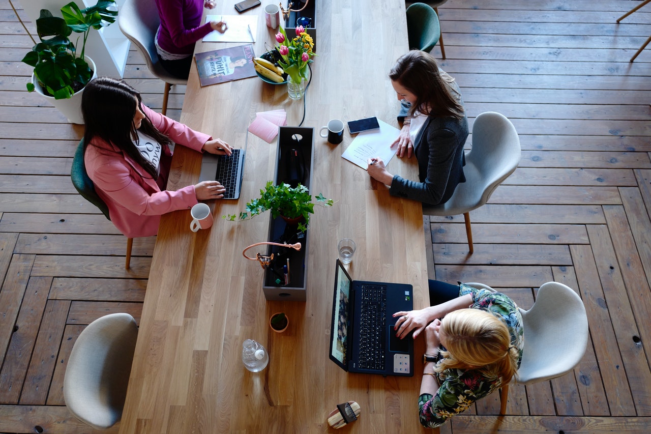 office workers laptops table above business
