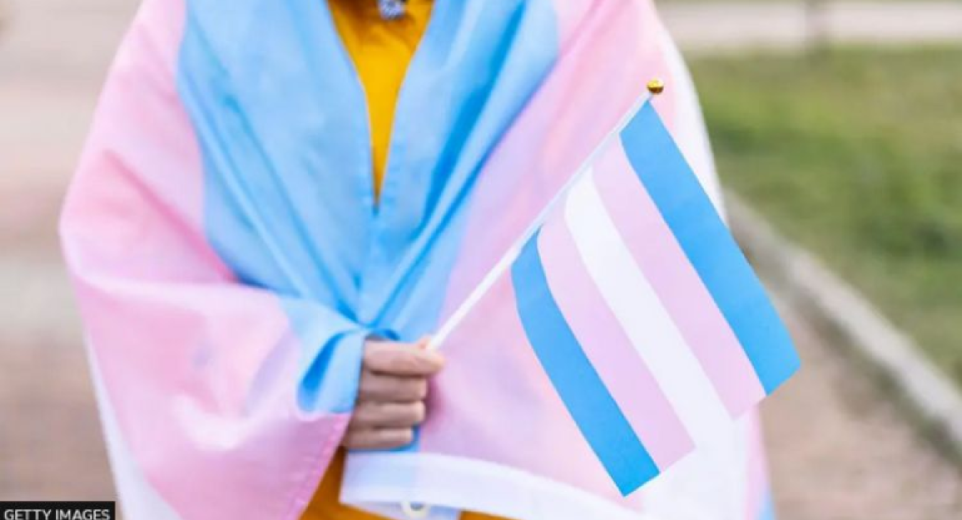 trans youth with flag